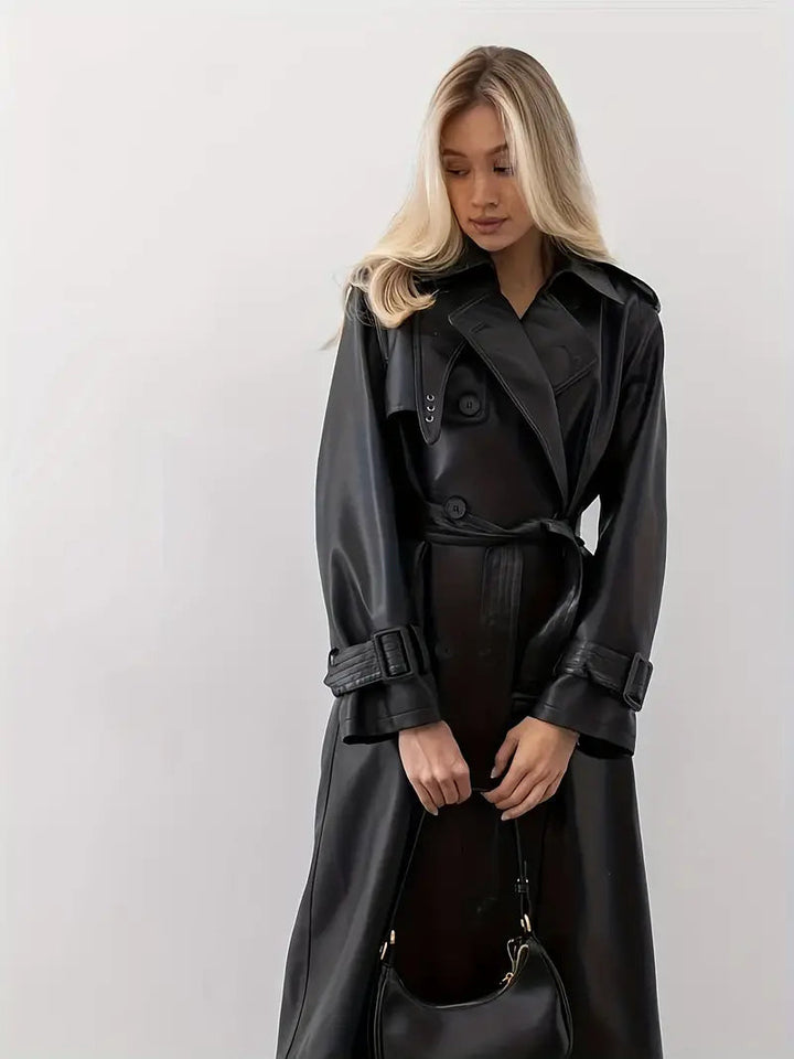 Women’s long black faux-leather trench coat with double-breasted front and belted waist