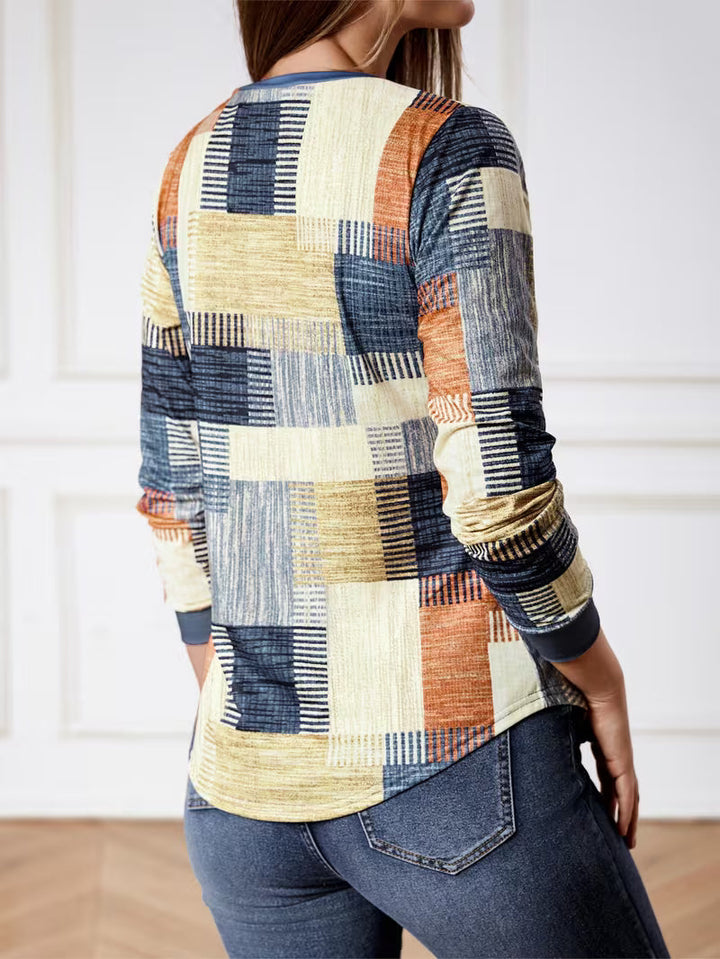 Back view of women’s long-sleeve patchwork top in blue, beige and orange tones