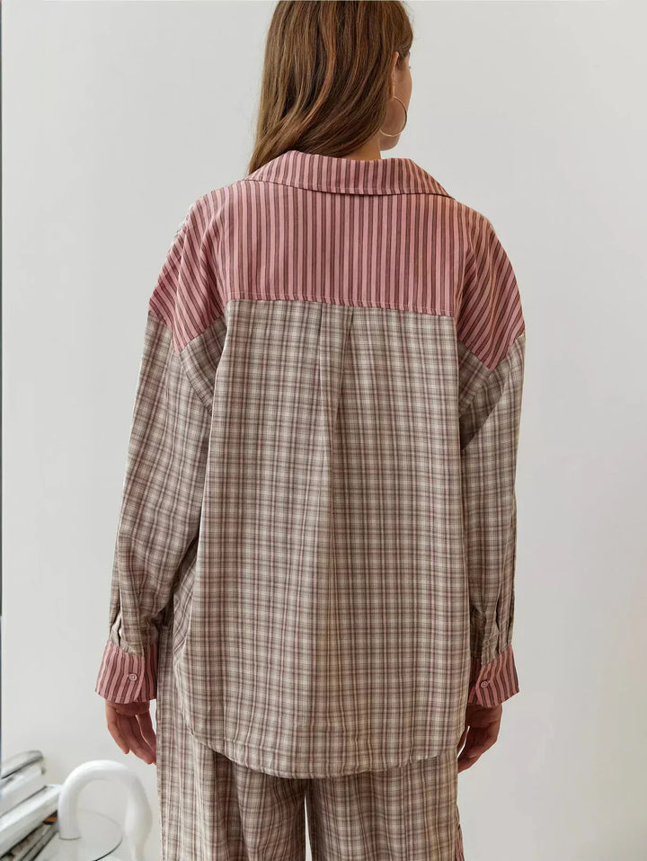Person wearing a plaid shirt with pink and brown color block design.